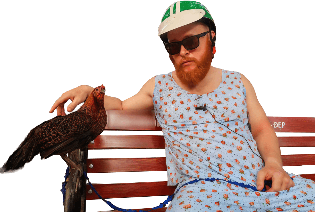 man sitting on bench in vietnamese style pajamas with a chicken